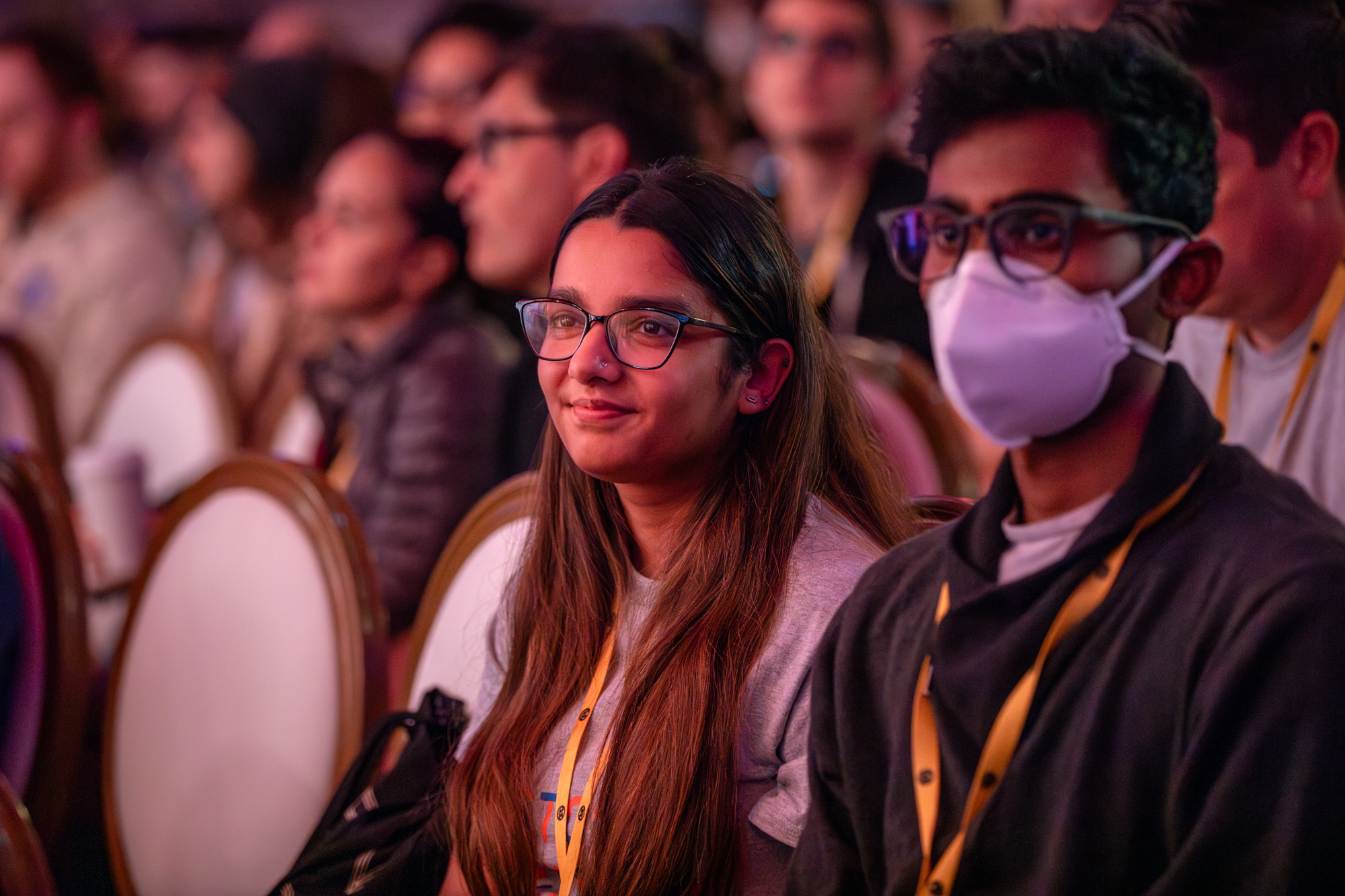 Smiling attendees in the audience at RustConf 2024